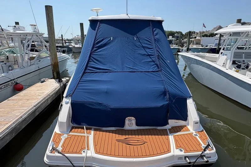 Slide: The Image of 2013 Chaparral 327 SSX boat with blue cover docked at marina. - 6