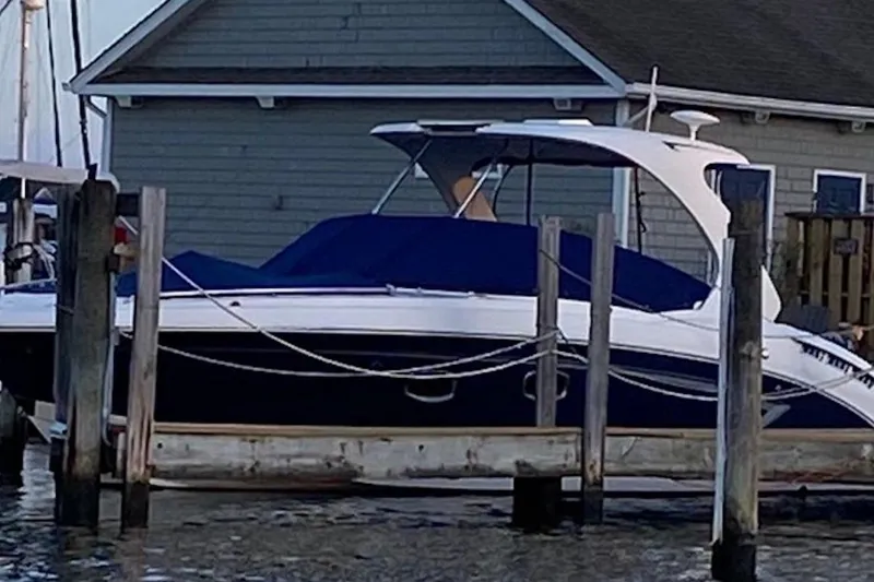 Slide: The Image of 2013 Chaparral 327 SSX boat docked near a wooden pier. - 4