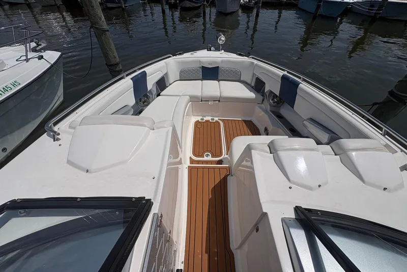 Slide: The Image of 2013 Chaparral 327 SSX boat interior with teak flooring and cushioned seating. - 13