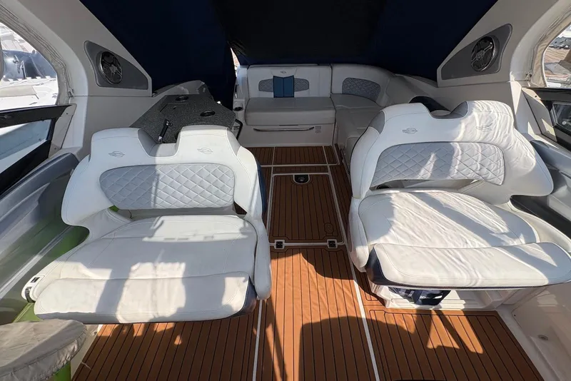Slide: The Image of Interior of 2013 Chaparral 327 SSX boat with luxurious white seating and wood flooring. - 10