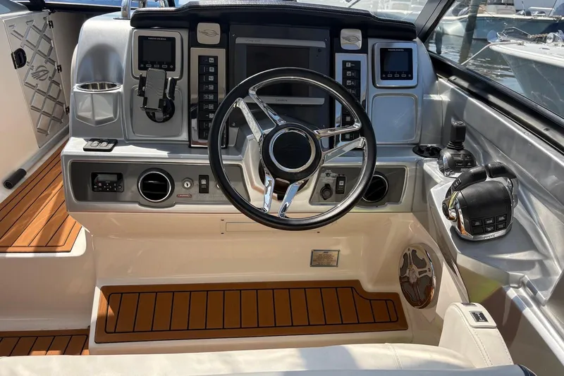 Slide: The Image of 2013 Chaparral 327 SSX boat dashboard with steering wheel and controls. - 7