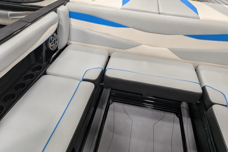 Slide: The Image of 2023 Axis A225 boat interior with gray and blue cushioned seating. - 31