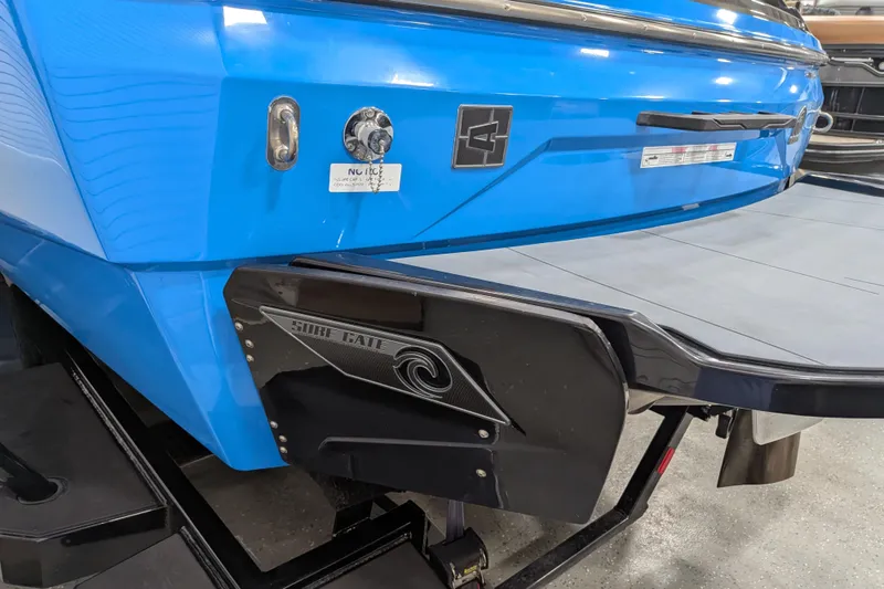 Slide: The Image of 2023 Axis A225 boat with blue hull and Surf Gate technology. - 23
