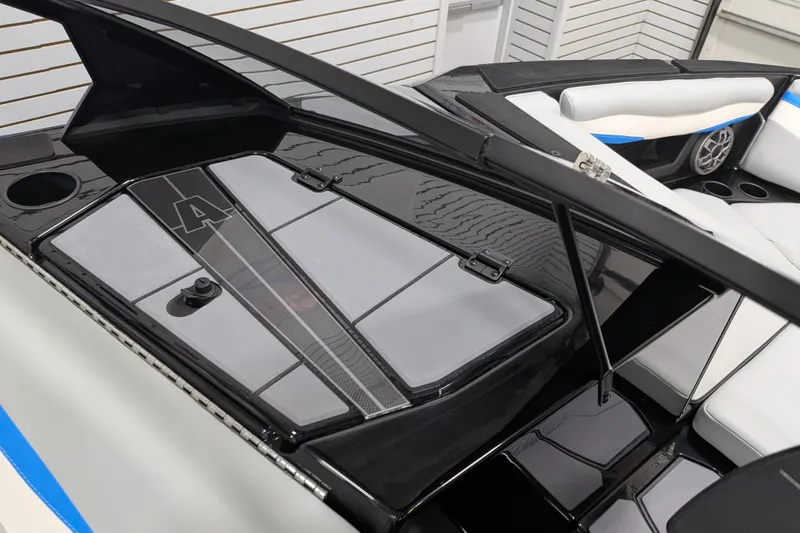 Slide: The Image of 2023 Axis A225 boat interior with sleek black and white design, featuring modern seating and audio system. - 28