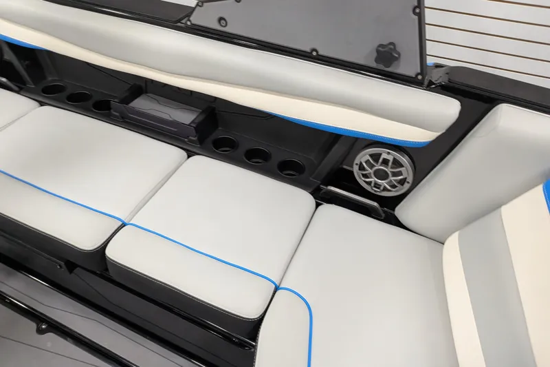Slide: The Image of 2023 Axis A225 boat interior with cushioned seating, cup holders, and speaker system. - 29