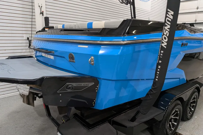 Slide: The Image of 2023 Axis A225 boat in showroom, featuring blue exterior and sleek design. - 11