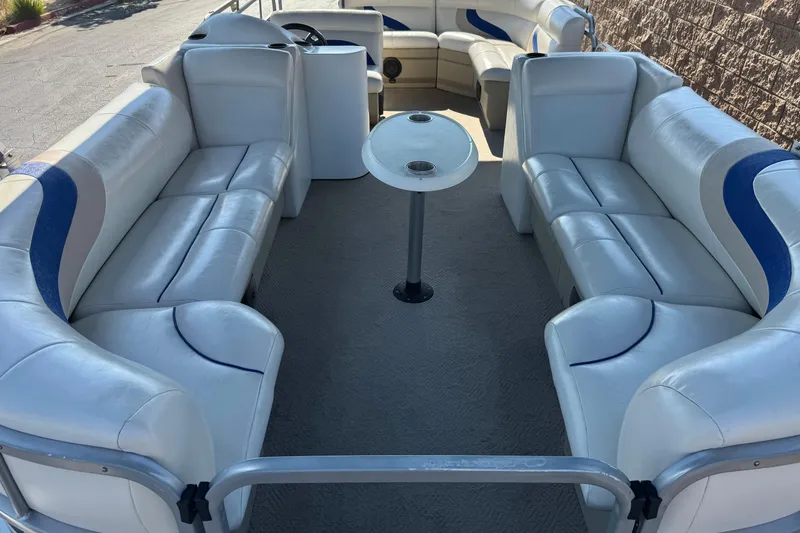Slide: The Image of 2014 Bentley Pontoons Encore 240 Cruise interior with white seating and central table. - 10