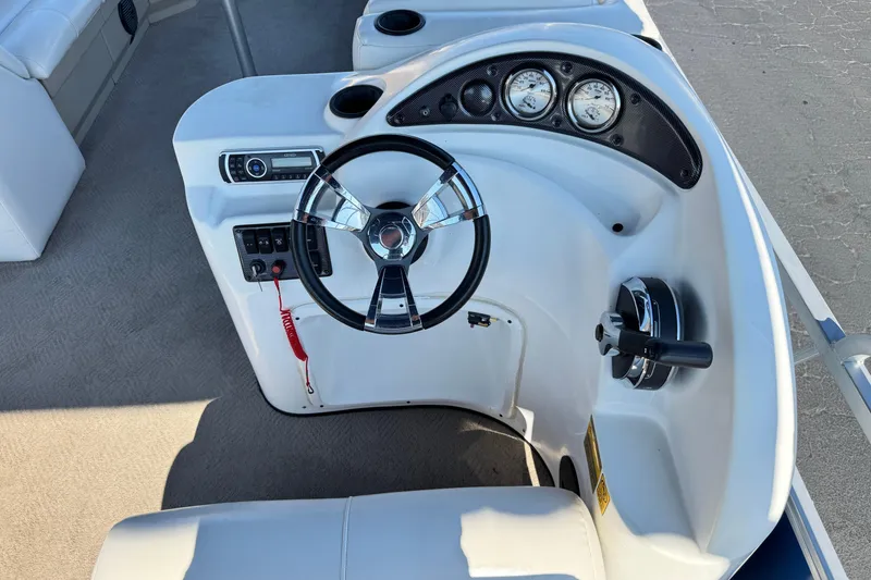 Slide: The Image of 2014 Bentley Pontoons Encore 240 Cruise helm with steering wheel and control panel. - 21