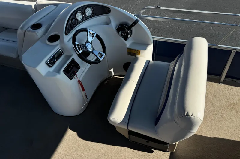 Slide: The Image of 2014 Bentley Pontoons Encore 240 Cruise helm with steering wheel and gauges. - 20