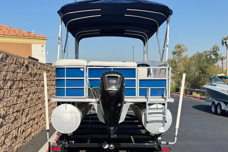 Slide: The Image of 2014 Bentley Pontoons Encore 240 Cruise with blue canopy and powerful outboard motor. - 5