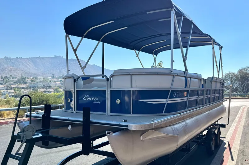 Slide: The Image of 2014 Bentley Pontoons Encore 240 Cruise on trailer, scenic mountain backdrop. - 3