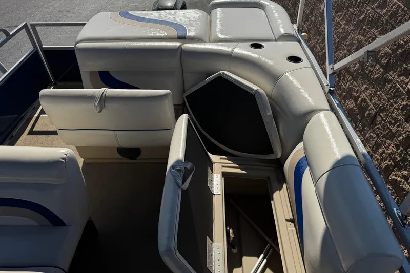 Slide: The Image of 2014 Bentley Pontoons Encore 240 Cruise interior with cushioned seating and storage compartments. - 15