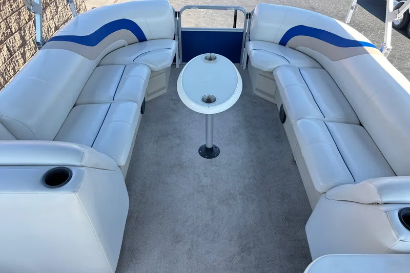Slide: The Image of 2014 Bentley Pontoons Encore 240 Cruise interior with plush seating and central table. - 11