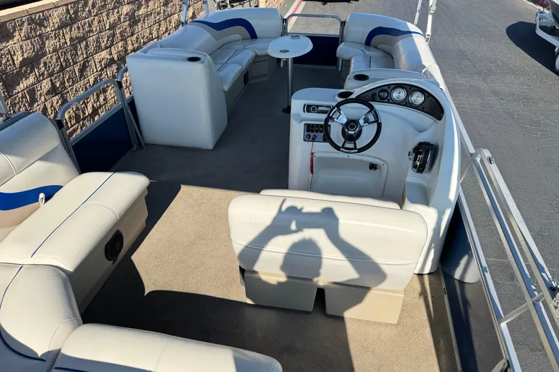 Slide: The Image of 2014 Bentley Pontoons Encore 240 Cruise interior with plush seating and steering console. - 18