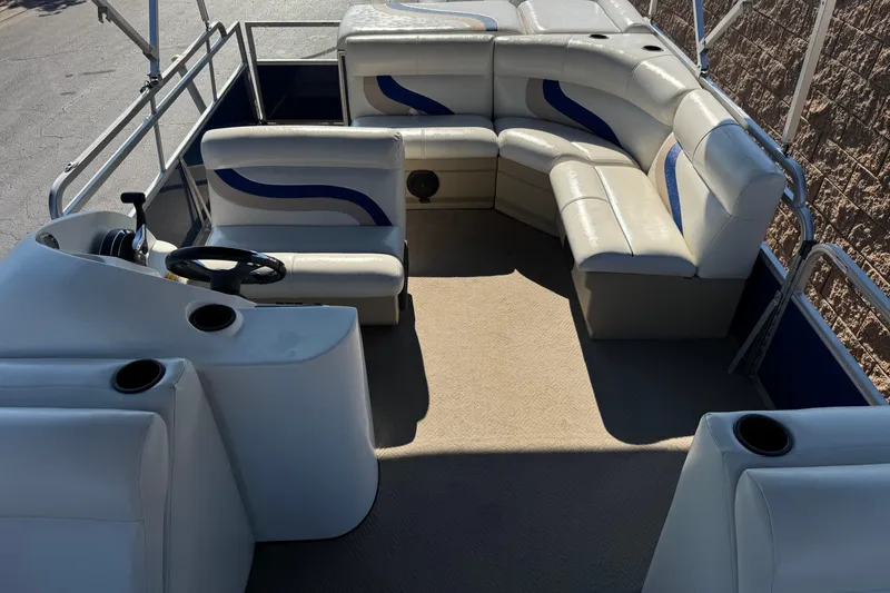 Slide: The Image of 2014 Bentley Pontoons Encore 240 Cruise interior with white seating and steering console. - 14