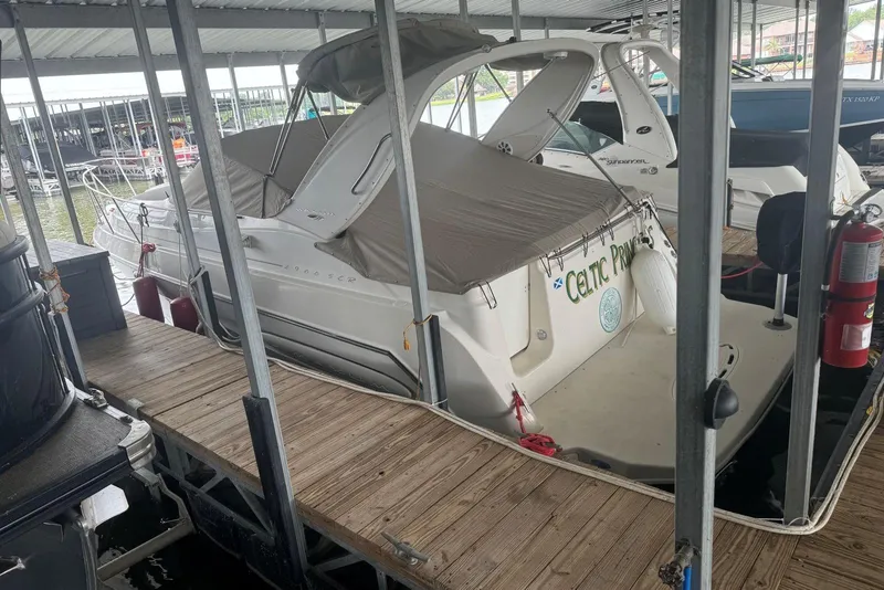 Slide: The Image of 2001 Maxum 2900 SCR boat docked under covered marina. - 2