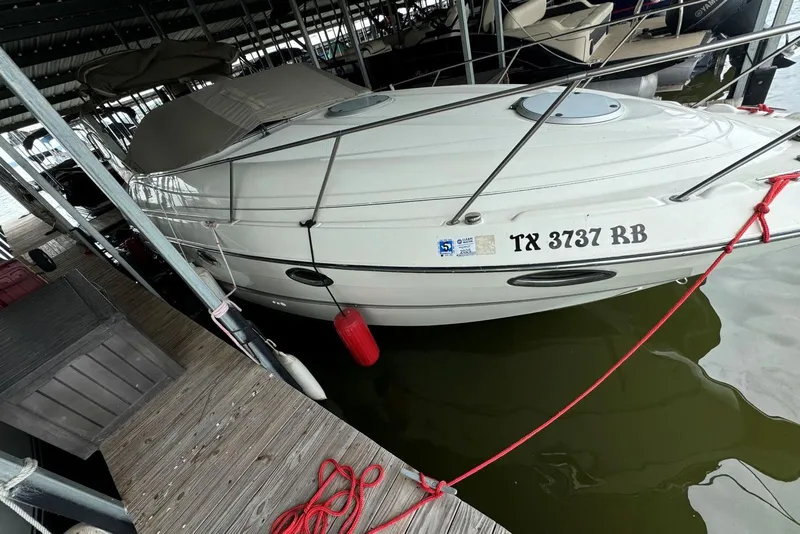 Slide: The Image of 2001 Maxum 2900 SCR boat docked, displaying registration TX 3737 RB. - 1
