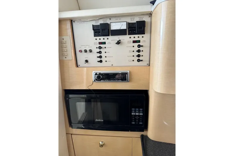 Slide: The Image of Control panel and microwave in 2001 Maxum 2900 SCR boat interior. - 9