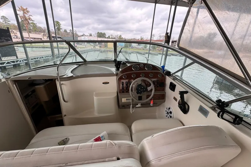 Slide: The Image of 2001 Maxum 2900 SCR boat cockpit with steering wheel and control panel, docked at marina. - 5