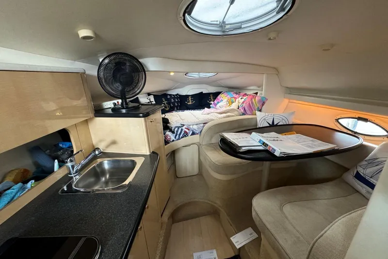 Slide: The Image of Interior of 2001 Maxum 2900 SCR boat with kitchenette, seating, and cozy sleeping area. - 6