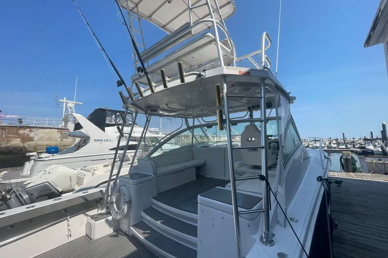 Slide: The Image of 1999 Luhrs 36 SX Open yacht docked at marina under clear blue sky. - 11