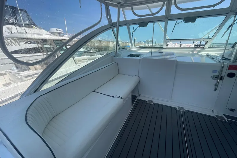 Slide: The Image of 1999 Luhrs 36 SX Open boat interior with white seating and clear windows. - 20