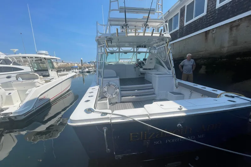 Slide: The Image of 1999 Luhrs 36 SX Open boat docked, named "Elizabeth Ann," in a marina setting. - 3