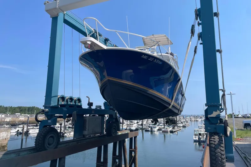 Slide: The Image of 1999 Luhrs 36 SX Open boat being lifted at a marina. - 43