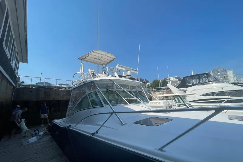 Slide: The Image of 1999 Luhrs 36 SX Open yacht docked at marina under clear blue sky. - 6