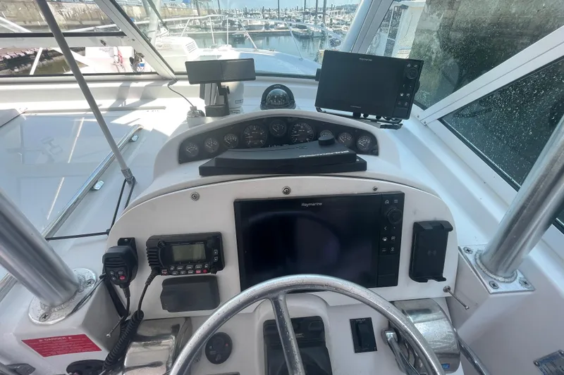 Slide: The Image of Helm of 1999 Luhrs 36 SX Open boat with navigation equipment and steering wheel. - 26