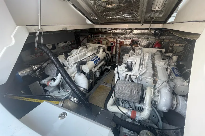 Slide: The Image of Engine room of a 1999 Luhrs 36 SX Open boat, showcasing dual engines. - 36