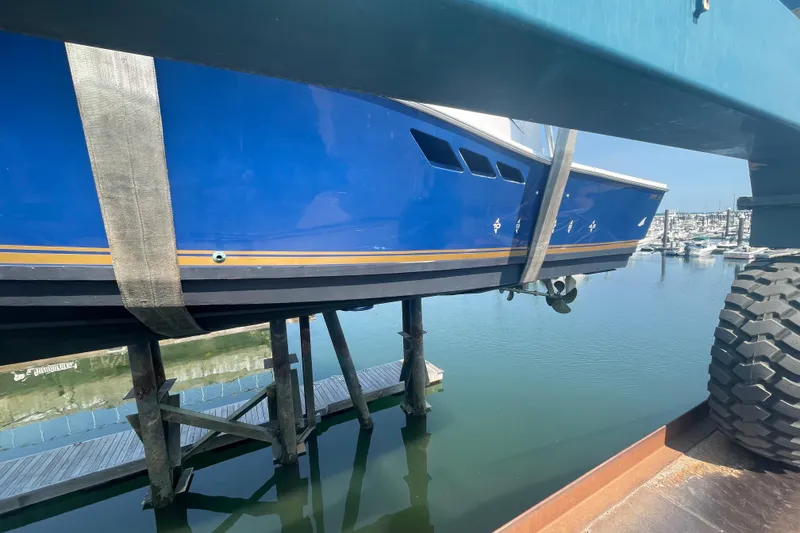 Slide: The Image of Blue 1999 Luhrs 36 SX Open boat suspended over water at a marina. - 46