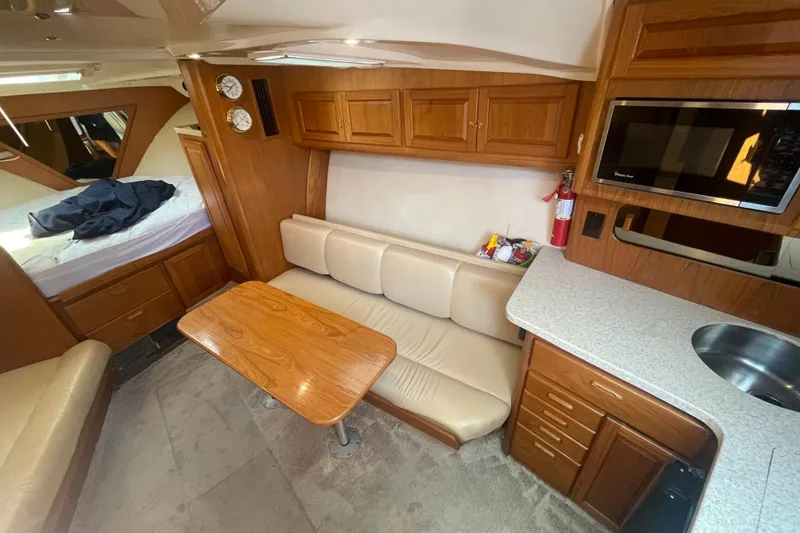 Slide: The Image of Interior of 1999 Luhrs 36 SX Open yacht with cozy seating and kitchenette. - 29