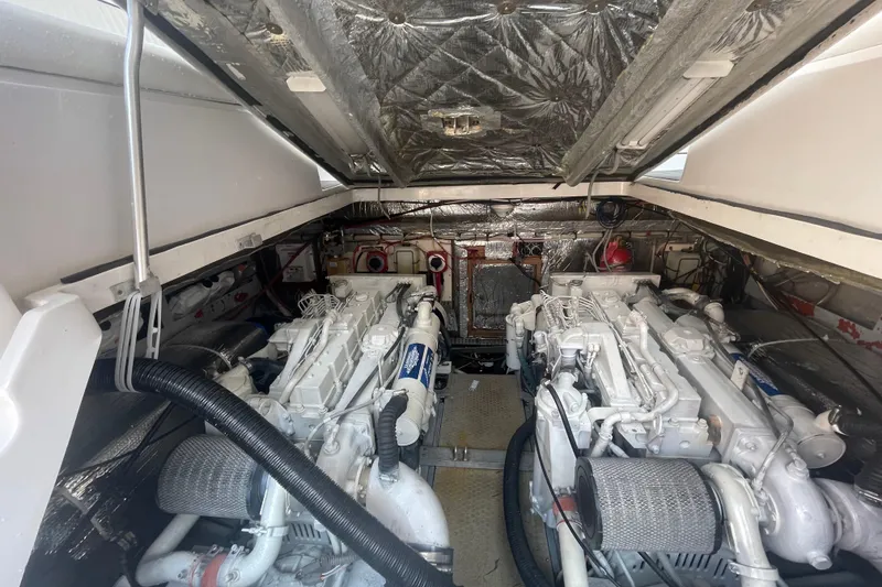 Slide: The Image of Engine room of a 1999 Luhrs 36 SX Open boat, showcasing dual engines. - 37