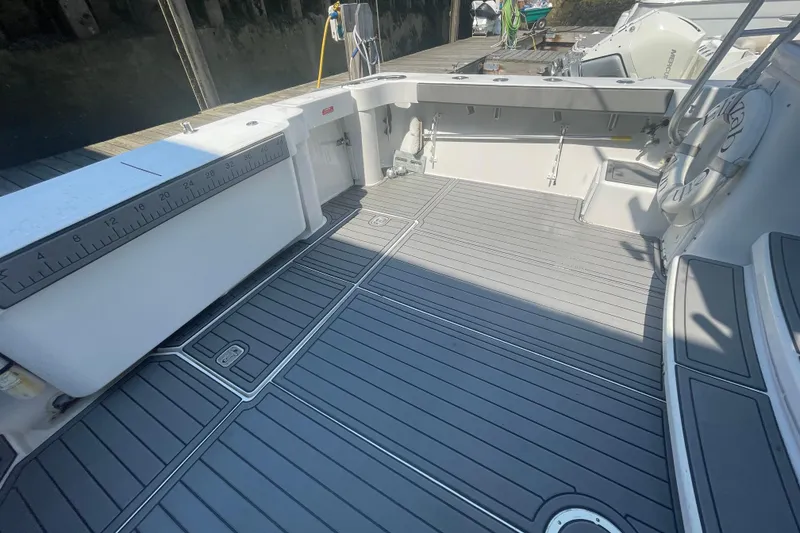 Slide: The Image of 1999 Luhrs 36 SX Open boat deck with measuring ruler and clean layout. - 14
