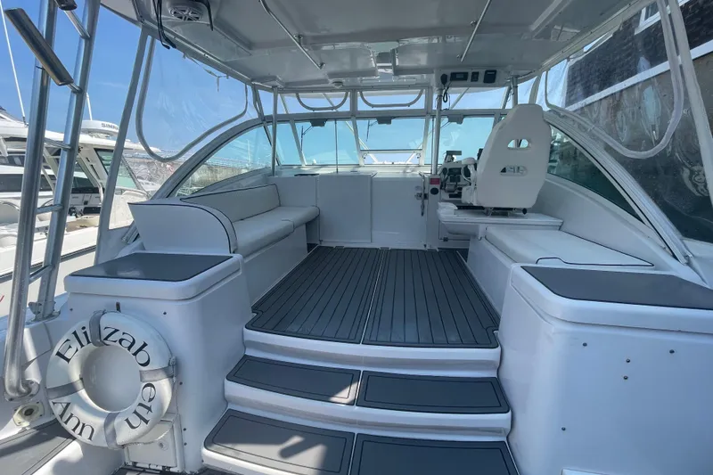 Slide: The Image of 1999 Luhrs 36 SX Open boat interior with seating and helm, featuring sleek design. - 16