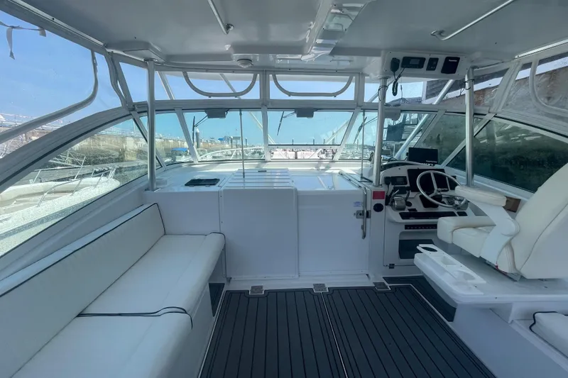 Slide: The Image of 1999 Luhrs 36 SX Open boat interior with helm, seating, and panoramic windows. - 19