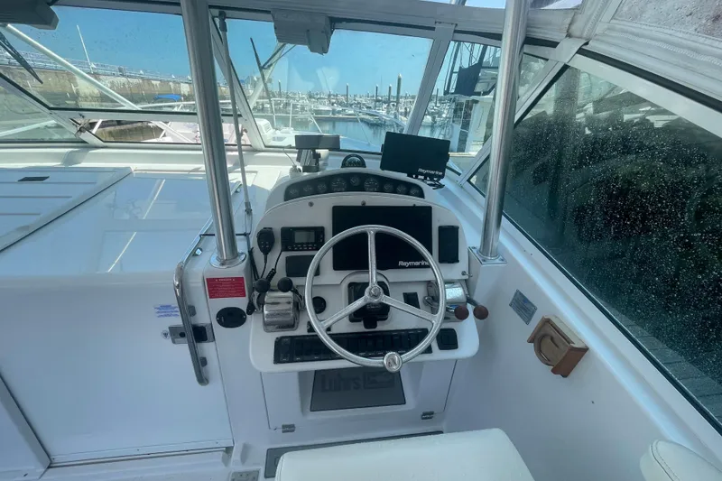 Slide: The Image of 1999 Luhrs 36 SX Open boat helm with steering wheel and navigation equipment. - 23