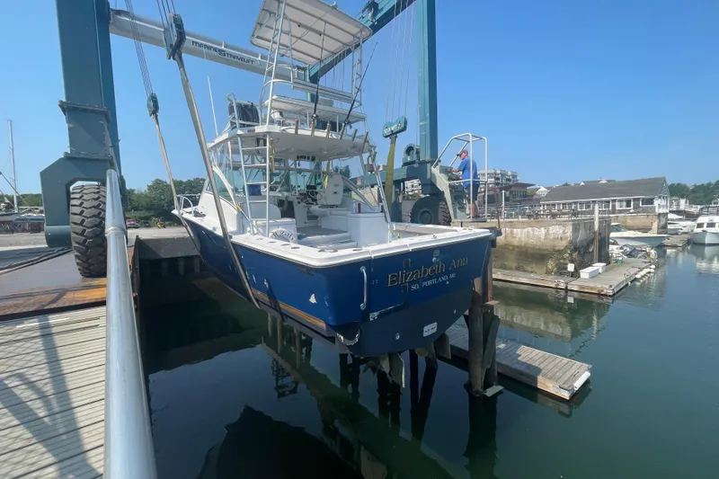 Slide: The Image of 1999 Luhrs 36 SX Open boat, "Elizabeth Ann," lifted at a marina dock. - 48