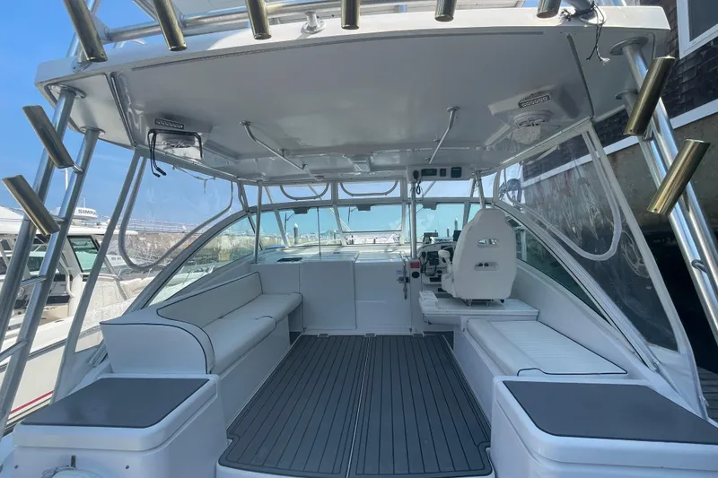 Slide: The Image of 1999 Luhrs 36 SX Open boat interior with seating and helm, showcasing modern design. - 17