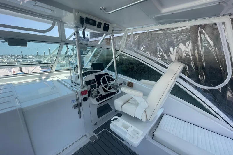 Slide: The Image of 1999 Luhrs 36 SX Open boat cockpit with steering wheel and captain's chair. - 21