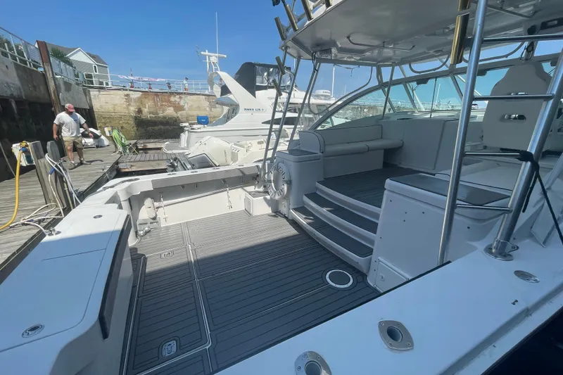 Slide: The Image of 1999 Luhrs 36 SX Open yacht docked, featuring spacious deck and seating area. - 10
