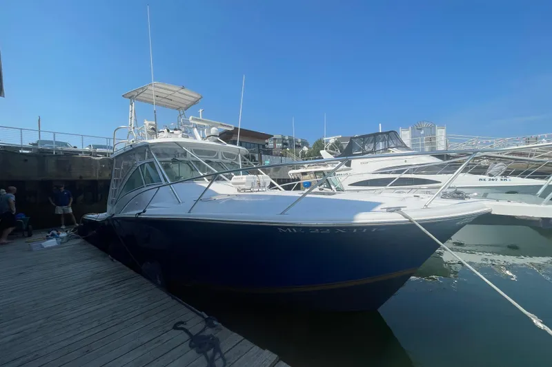 Slide: The Image of 1999 Luhrs 36 SX Open boat docked at marina under clear blue sky. - 7