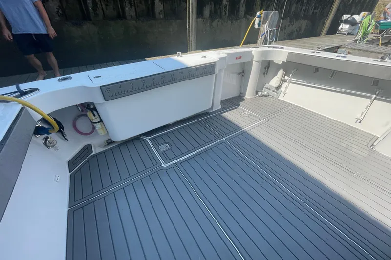Slide: The Image of 1999 Luhrs 36 SX Open boat deck with gray flooring and measuring ruler. - 13