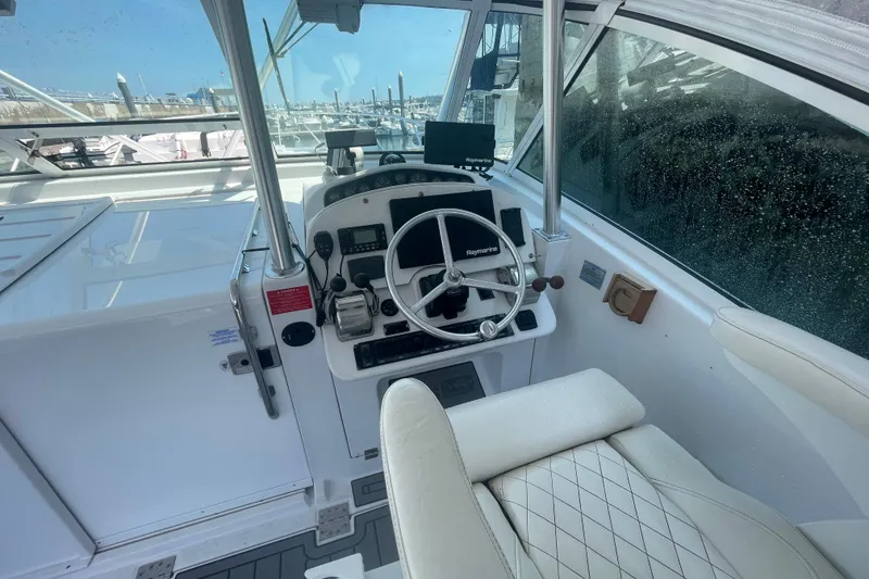 Slide: The Image of 1999 Luhrs 36 SX Open boat helm with steering wheel and navigation equipment. - 22