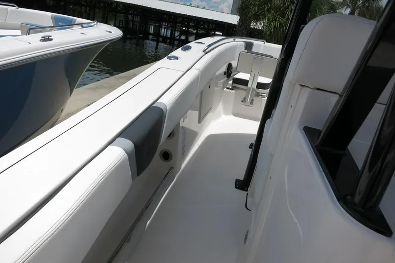 Slide: The Image of 2026 Robalo R270 Center Console boat interior, showcasing sleek white seating and modern design. - 53