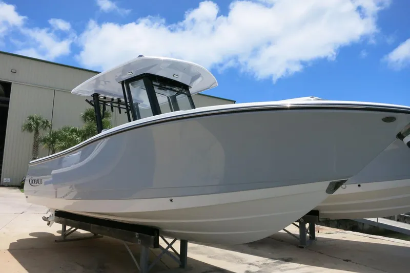 Slide: The Image of 2026 Robalo R270 Center Console boat displayed outdoors under a clear blue sky. - 3
