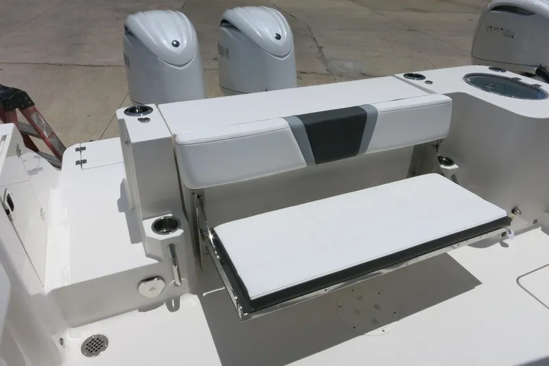 Slide: The Image of 2026 Robalo R270 Center Console boat with foldable seating and dual outboard engines. - 10