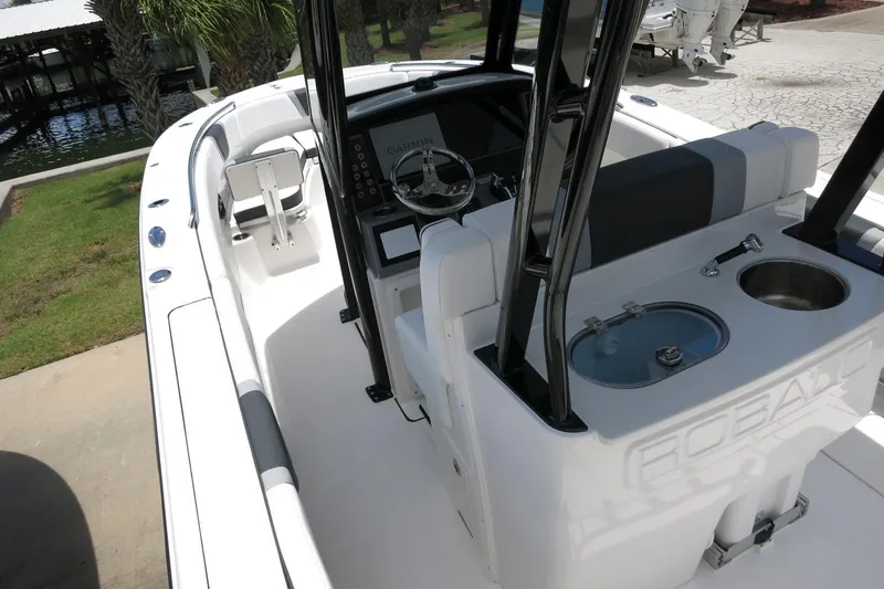 Slide: The Image of 2026 Robalo R270 Center Console boat interior with helm, seating, and fishing amenities. - 49