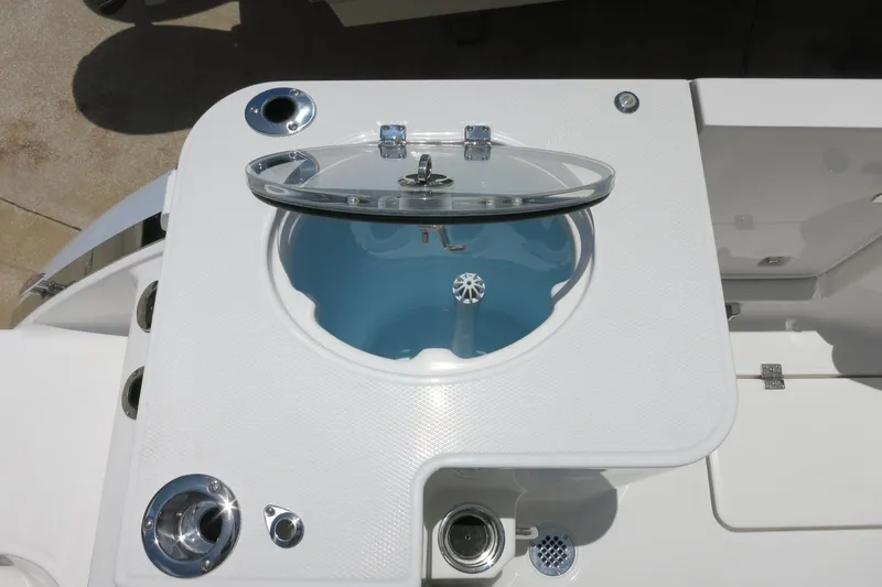 Slide: The Image of Livewell on 2026 Robalo R270 Center Console boat, featuring a clear lid and white finish. - 15
